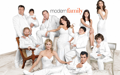 A group of people dressed in white clothing posing against a white background.