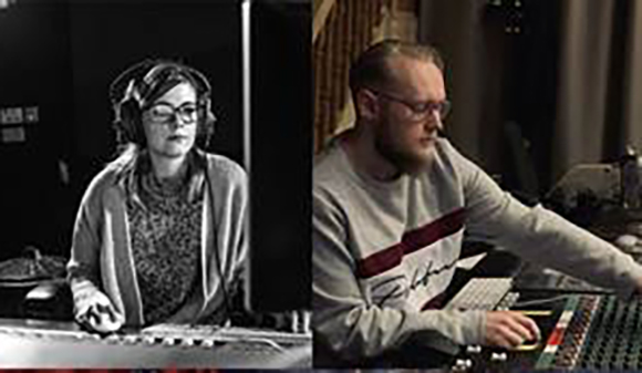 A woman in headphones and a man at a mixing console in a studio setting.