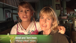 A young girl and a blonde woman smiling closely together indoors.