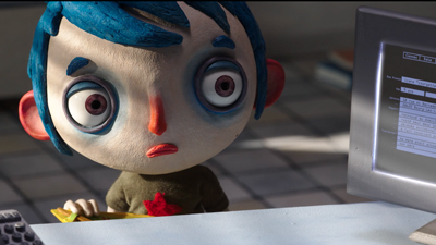 An animated character with blue hair and large eyes stares intently at a computer monitor.