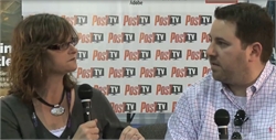 A woman with glasses and a man in a checkered shirt talk while holding microphones in front of a Post TV backdrop.