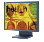 A computer monitor displaying a yellow graphic with the word 'health' and circular biological patterns.