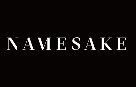 The word NAMESAKE written in white serif capital letters against a solid black background.