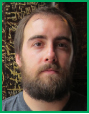 A man with brown hair and a full beard looking directly at the camera.