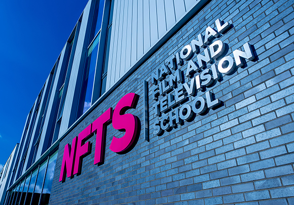 The National Film and Television School building exterior with large pink NFTS lettering and silver 3D text reading National