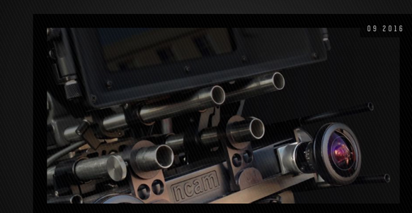 Close-up of a complex motion control camera rig with metal tubes and a large lens.