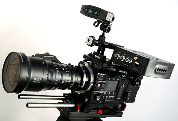 A professional cinema camera with a large Fujinon lens, mounted on a tripod with a top-mounted monitor.