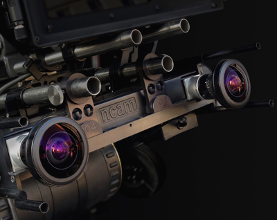 Close-up of a complex metal motion control camera rig with multiple lenses and mechanical components.
