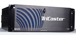A black TriCaster video production device with blue curved grille patterns on the front panel.