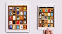 Two white tablets side by side showing various digital book covers on wooden shelves.