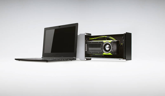 A laptop connected via cable to an open external hardware enclosure containing a large graphics card.