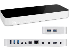 A white rectangular docking station shown from three angles, displaying various USB, Ethernet, and HDMI ports.