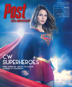 Supergirl in costume with cape, standing heroically against a dramatic sky.