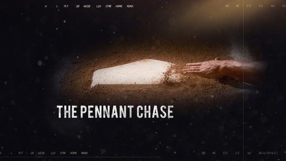 A baseball player's hand sliding into a dirt base under a spotlight.