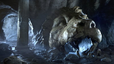 A giant, cracked stone lion head sculpture inside a dark, rocky cavern next to a tall fluted column.