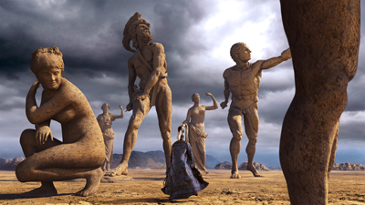 A person in a dark cloak stands in a desert facing several massive, ancient stone statues under a cloudy sky.