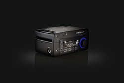 A black rectangular electronic device with a small digital screen and a blue illuminated circular dial.