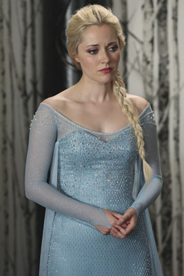 A blonde woman wearing a sparkling light blue gown with long sheer sleeves and a long braid.