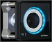 A black square industrial camera with a circular blue LED ring around the lens and a silver mounting bracket.