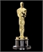 A gold Oscar statuette of a standing man holding a sword, set against a black background.