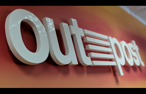 Large white 3D letters spelling 'Outpost' against a red and orange gradient background.