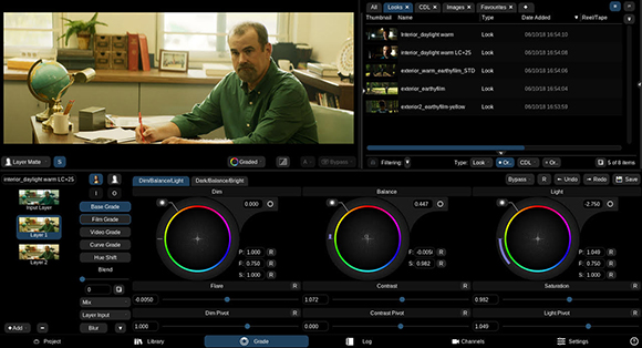 Color grading software interface showing a video of a man sitting at a desk and various color adjustment tools.