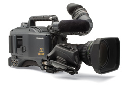 A gray Panasonic professional video camera with a large lens and microphone on a white background.