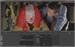 A person in clown makeup with red hair and a man leaning in to look at a monitor.