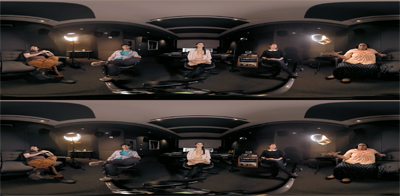 Six people sit in chairs arranged in a circle within a dark, dimly lit room.