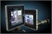 Two rectangular digital monitors displaying video images against a dark blue background.