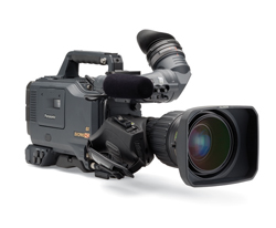 A professional black video camera with a large lens and a viewfinder on a white background.