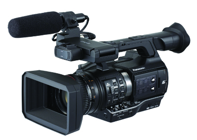 A professional black Panasonic video camera equipped with a shotgun microphone and a large lens hood.