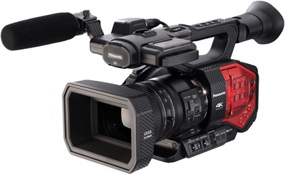 A black Panasonic 4K professional video camera with a large lens and a microphone with a foam windscreen.