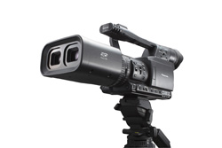A black professional video camera mounted on a tripod against a white background.