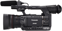 A black Panasonic professional video camera with a large lens and a shotgun microphone attached to the top.