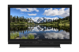 A black Panasonic television showing a scenic mountain lake reflection.