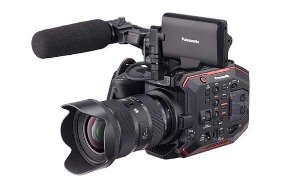 A black Panasonic professional video camera with a large lens and a foam-covered microphone.