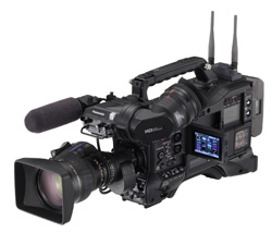 A professional black digital video camera with a large lens, top handle, and two antennas.