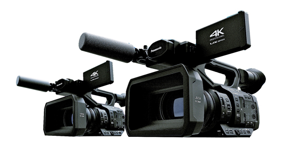 Two black Panasonic professional 4K video cameras with large lenses and viewfinders on a white background.