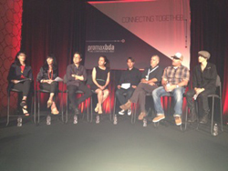Seven people sit on a stage in front of a screen with the words "CONNECTING TOGETHER" and a logo.