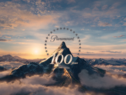 Paramount 100 Years logo centered over a snow-capped mountain peak during a golden sunset.