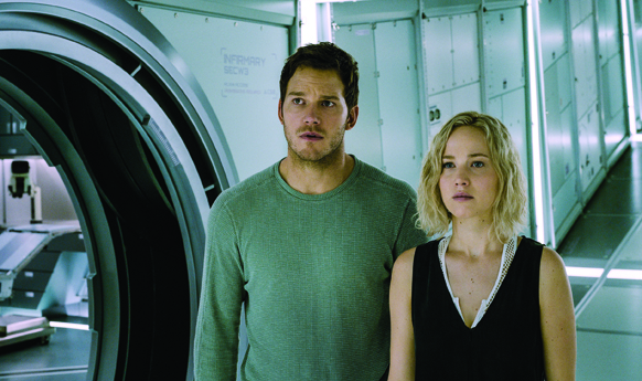 A man in a green shirt and a woman in a black top look ahead in a bright, metallic corridor.