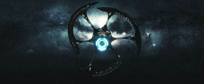 A dark, three-armed spacecraft with a glowing blue center floating against a starry nebula background.
