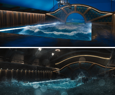 An indoor pool with blue lighting features crashing waves under a large decorative archway.