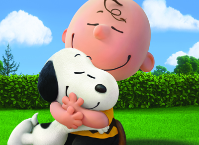 Charlie Brown smiling with his eyes closed while hugging Snoopy in a grassy field under a blue sky.