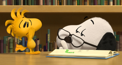 A small yellow bird and a white beagle look down at an open book on a wooden surface.