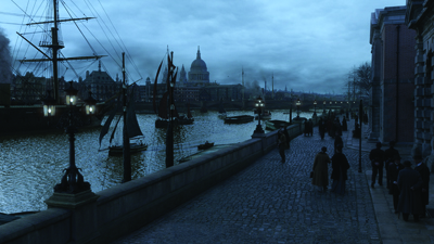 A cobblestone walkway along a river with sailing ships and a domed city skyline under a dark blue sky.