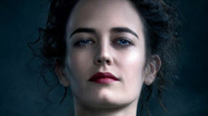 Close-up portrait of a woman with dark curly hair, blue eyes, and dark red lipstick looking forward.