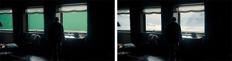 A man in a dark room stands before a large window overlooking a vast, snowy mountain landscape.