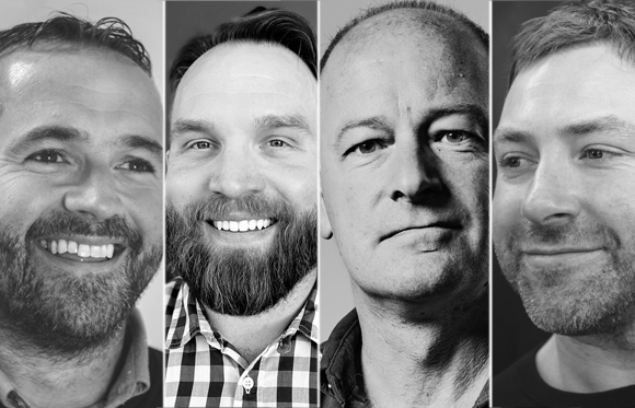 Four black and white close-up portraits of men smiling or looking neutral.